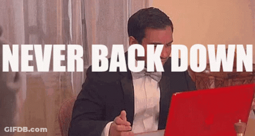 Man In Tuxedo Sitting At Laptop Never Back Down GIF