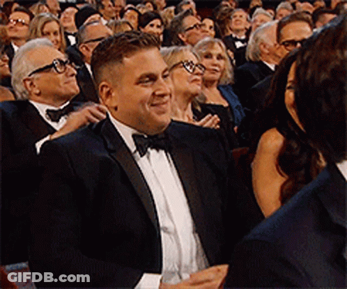 Man In Tuxedo Sitting In Crowd GIF