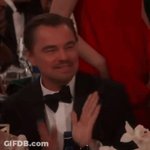 Man In Tuxedo Smiling At Table GIF