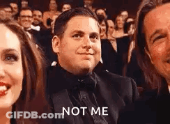 Man In Tuxedo Smiling In Crowd GIF