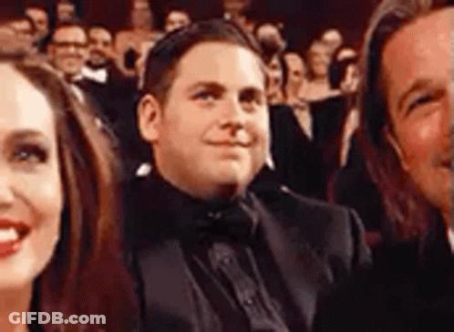 Man In Tuxedo Smiling In Crowd GIF