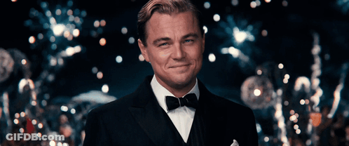Man In Tuxedo Smiling In Front Of Crowd GIF