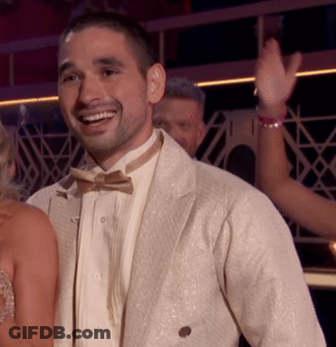 Man In Tuxedo Smiling In Front Of Woman GIF