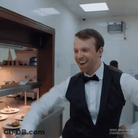 Man In Tuxedo Smiling In Kitchen Speel Bewust 18+ GIF