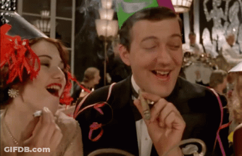 Man In Tuxedo Smoking Cigar With Laughing Woman GIF