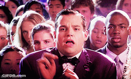 Man In Tuxedo Smoking Cigarette In Crowd Mufffliato GIF