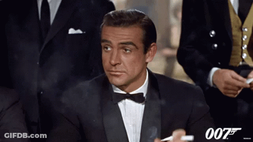 Man In Tuxedo Smoking Cigarette With 007 Logo GIF