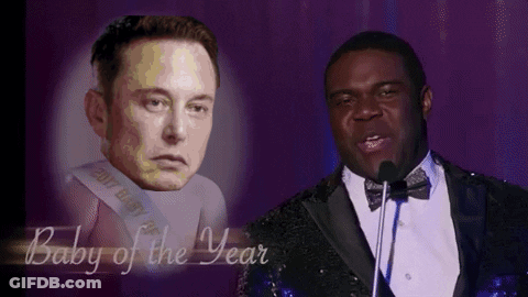 Man In Tuxedo Speaking Into Microphone Next To Elon Musk GIF