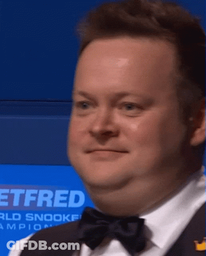 Man In Tuxedo Standing In Front Of Sign Saying Ttfred GIF