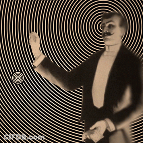 Man In Tuxedo Standing In Front Of Spiral GIF