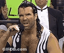 Man In Tuxedo Standing In Wrestling Ring GIF