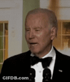 Man In Tuxedo Talking Into Microphone GIF