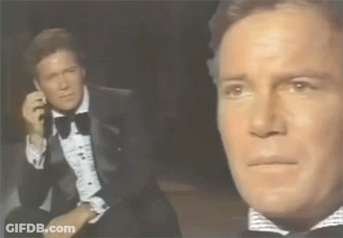 Man In Tuxedo Talking On Phone GIF