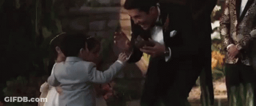 Man In Tuxedo Talking To Little Girl GIF