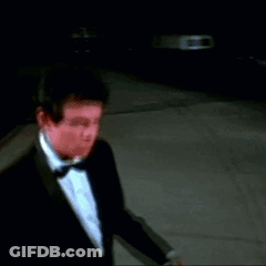 Man In Tuxedo Walking Down Street GIF