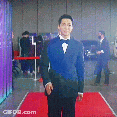 Man In Tuxedo Walking On Red Carpet GIF