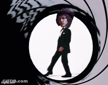 Man In Tuxedo Walking Through Circle Gun Barrel GIF
