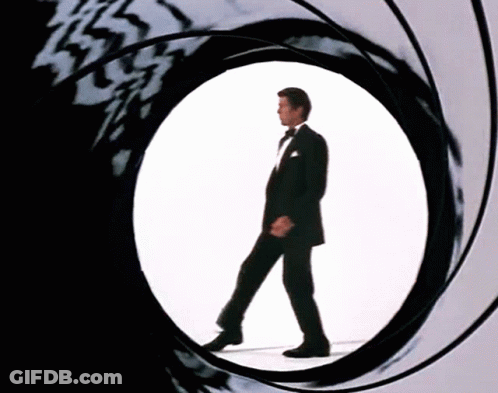 Man In Tuxedo Walking Through Circular Hole GIF