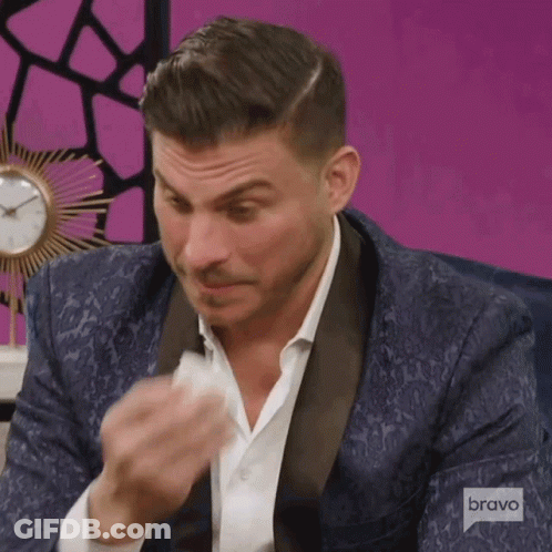 Man In Tuxedo Wiping Face With Bravo Logo GIF