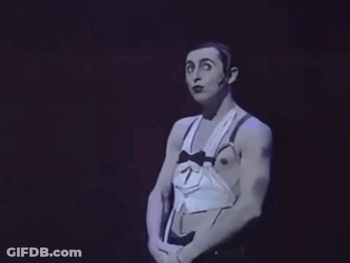 Man In Tuxedo With Bow Tie And Suspenders Making Funny Face GIF