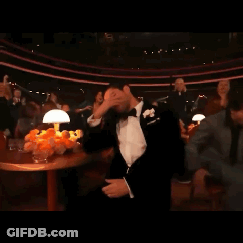 Man In Tuxedo With Bow Tie Covering Face GIF