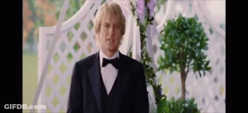 Man In Tuxedo With Bow Tie In Front Of Archway GIF