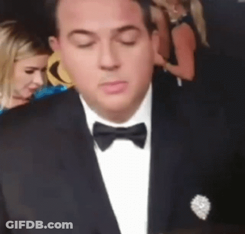 Man In Tuxedo With Bow Tie Looking Down GIF