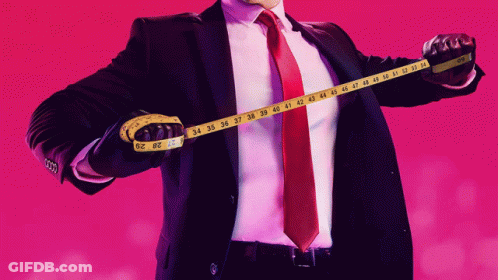 Man In Tuxedo With Bow Tie Looks At Another Man GIF
