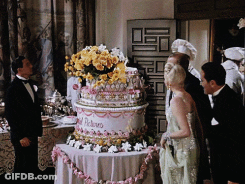 Man In Tuxedo With Cake Saying Gold Pictures GIF