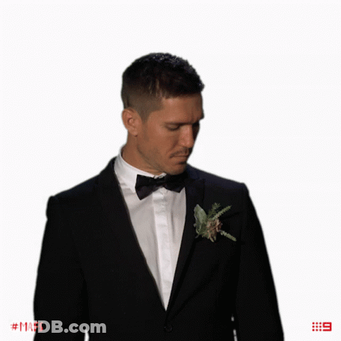 Man In Tuxedo With Flower And Number 9 GIF