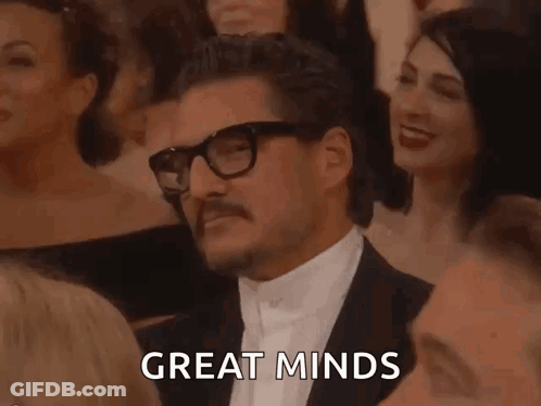 Man In Tuxedo With Glasses And Mustache Sitting In Crowd GIF