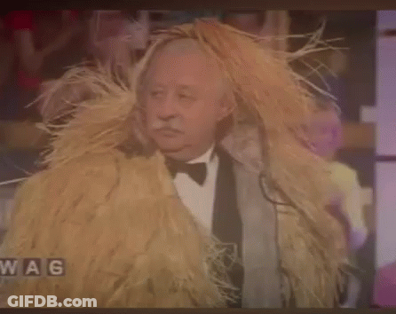 Man In Tuxedo With Hay Wig GIF