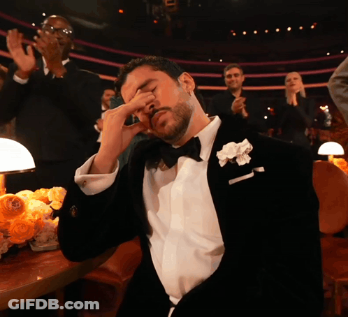 Man In Tuxedo With White Flower Covering Eyes GIF