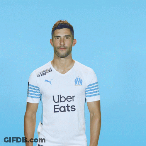 Man In Uber Eats Shirt On Blue Background GIF