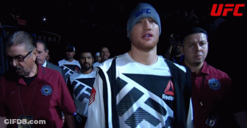 Man In UFC Beanie Walks Through Crowd GIF