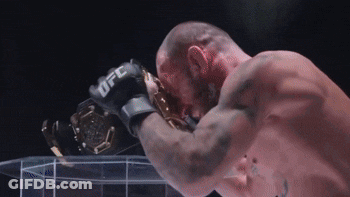 Man In UFC Glove Holding Trophy GIF
