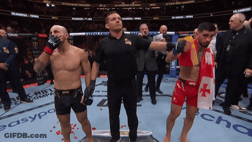 Man In UFC Glove Stands Next To Another Man GIF
