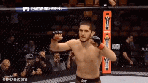 Man In UFC Ring In Front Of Performance Inspired Banner GIF
