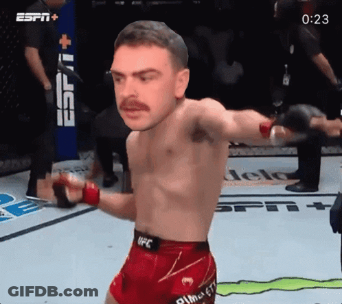 Man In UFC Shorts In Front Of ESPN+ Sign GIF