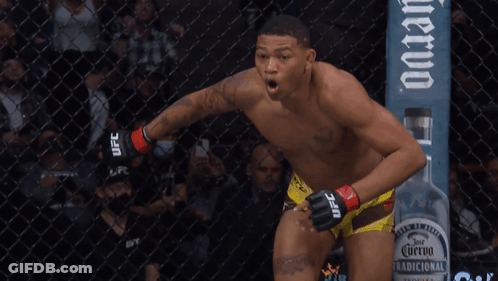 Man In UFC Shorts In Front Of Fence GIF