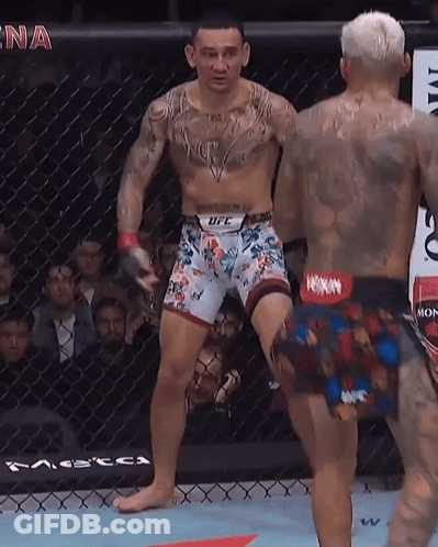 Man In UFC Shorts Next To Man In Boxing Ring GIF