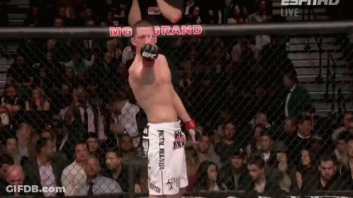 Man In UFC Shorts Standing In Crowd GIF