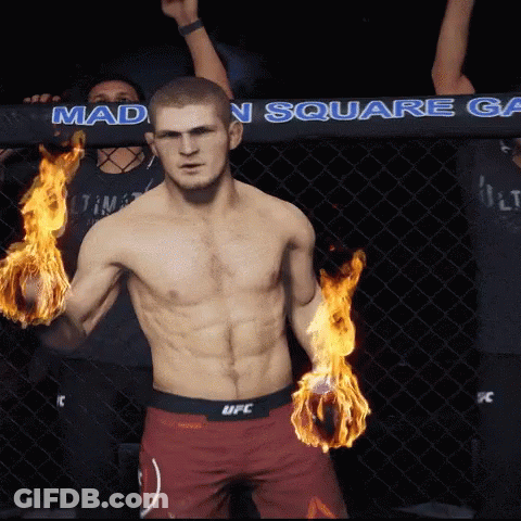 Man In UFC Shorts With Flames In Hands GIF