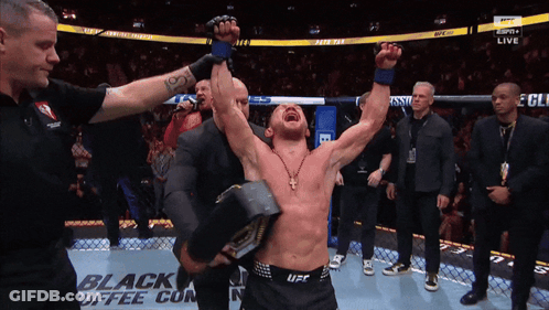 Man In UFC Uniform Holding Hammer GIF