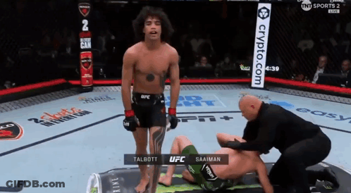 Man In UFC Uniform Stands Next To Another Man GIF
