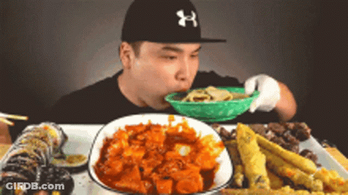 Man In Under Armour Hat Eating Noodles GIF