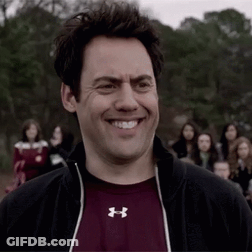 Man In Under Armour Shirt Smiling In Crowd GIF