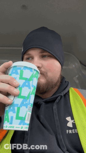 Man In Under Armour Vest Drinking Cup Saying Large GIF