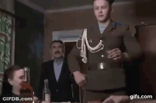 Man In Uniform Holding Shot Glass With Group GIF