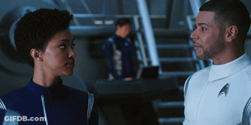 Man In Uniform With Letter A Standing Next To Woman GIF